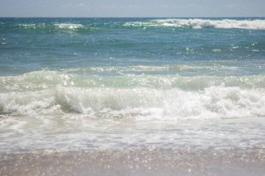 Summer background. Waves in the blue sea on a sunny day. Azure ocean with big waves.