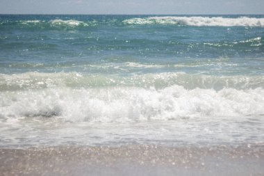 Summer background. Waves in the blue sea on a sunny day. Azure ocean with big waves.