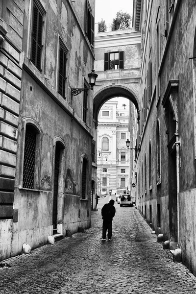 A typical street in Rome black and white person looking up, Rome Italy