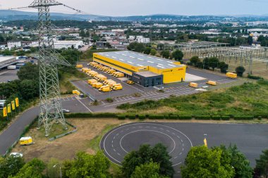 Koblenz GERMANY 21.07.2018 : Aerial view of the DHL distribution centre with its connection to the highway clipart