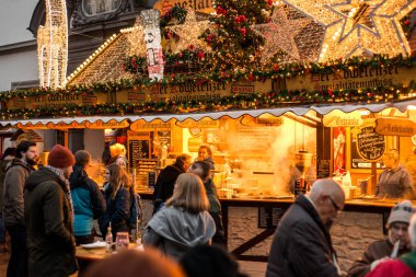 Koblenz GERMANY 16.12.2017 imbiss selling food meat and sausages Traditional Christmas market by night clipart