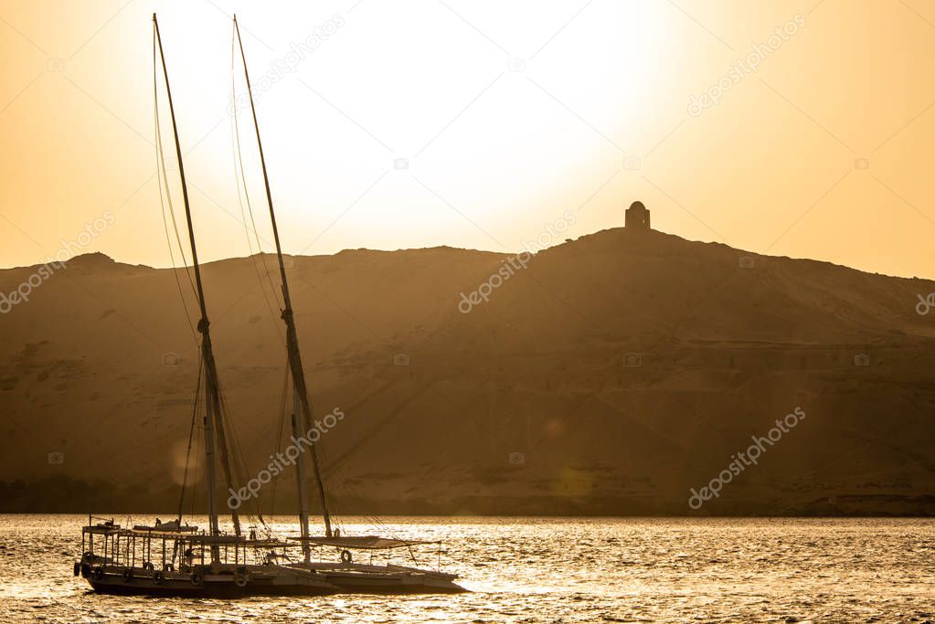 sunset Nile Aswan and the West Bank with Tombs Old Kingdom Qubbet el-Hawa - Dome of the Winds at the crest of the hill