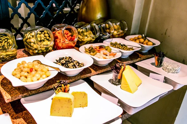 Variety food buffet table, wine snack set, olives, cheese and other appetizer, italian antipasti on plate in Egypt
