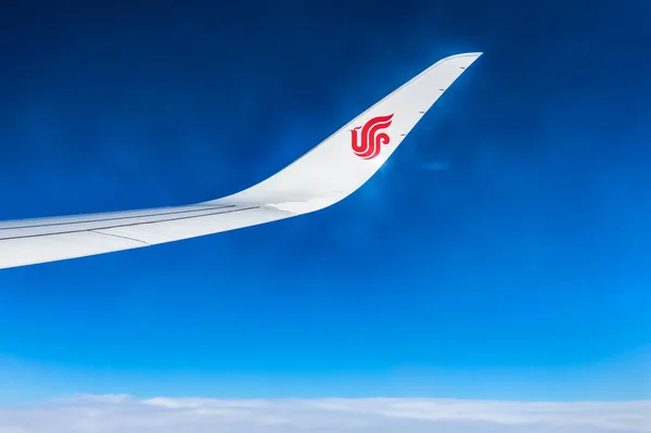 Air China wing of airplane in the sky red winglet blue sky clouds — Stock Photo, Image
