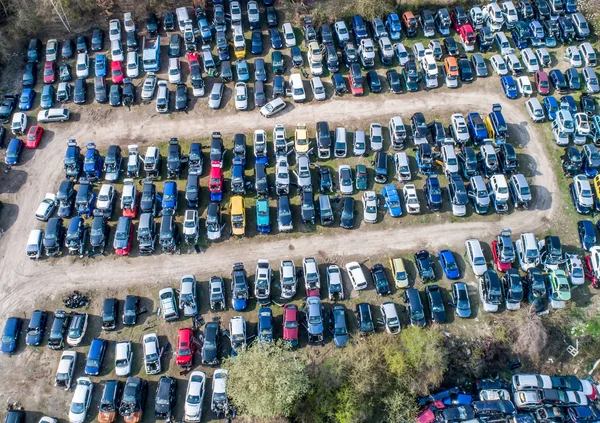 Lines of crushed cars wreck in scrapyard before being shredded recyling