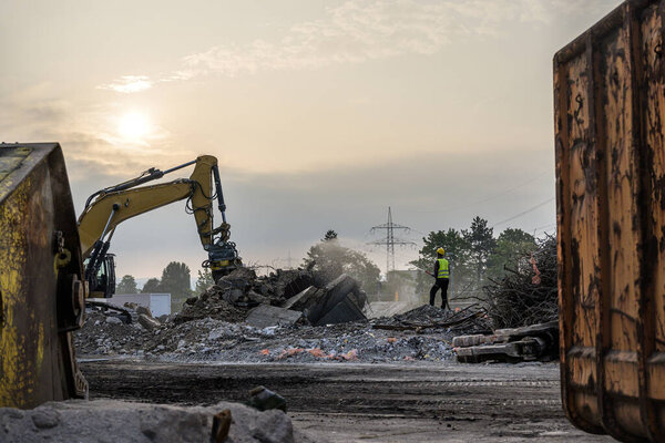 Building House destruction Demolition site Excavator with hydraulic crusher machine ruin house