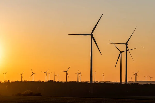 Black Silhouette of windturbines energy generator on amazing sunset at a wind farm in germany — Stock Photo, Image