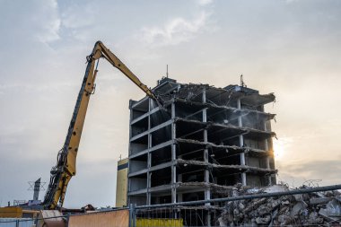 Bina Yıkım Alanı Kazıcı Hidrolik parçalama makinesi ve sarı konteynırlı