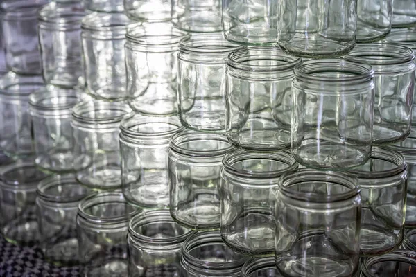 many glass jar empty glasses row for jam honey with lid caps abstract background bokeh