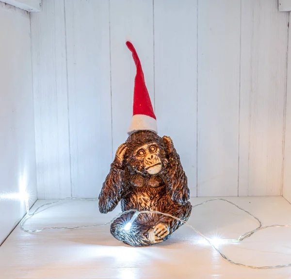 The Three Monkeys Sculpture Do not Hear christmas decoation santa hat and lights