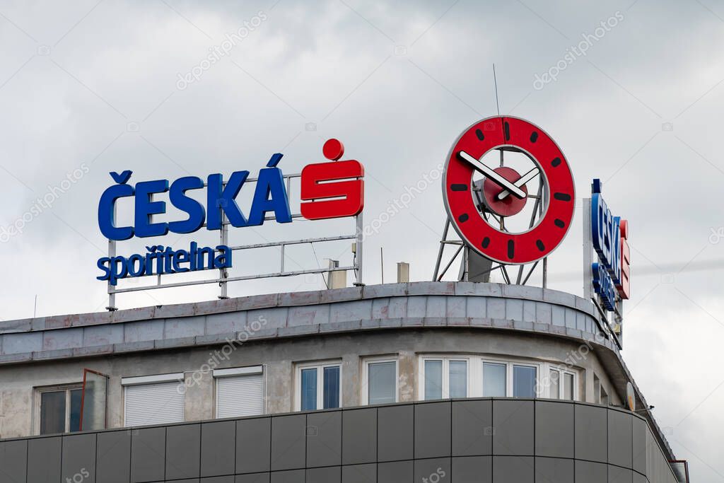 PRAGUE, CZECHIA - 30. May 2025: Ceska sporitelna (Czech Savings Bank) logo sign at the building exterior. Financial services for people in the Czech Republic. House with a big red clock.