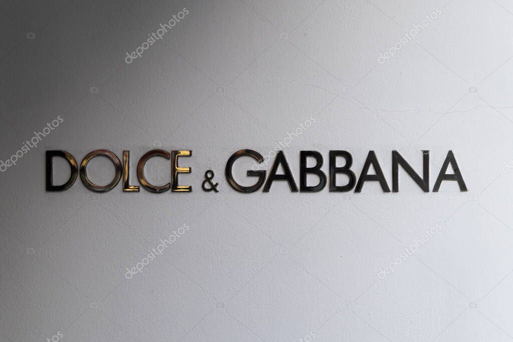 PRAGUE, CZECHIA - 29. May 2025: Dolce Gabbana logo signage on a white wall. Boutique of the Italian luxury fashion designers in a shopping street. Close-up of an advertisement sign of the brand.