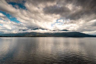 Rain clouds over the mountain and lake Como, Italy