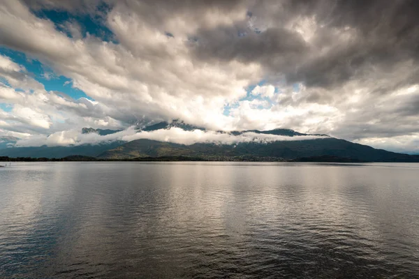 Rain clouds over the mountain and lake Como, Italy