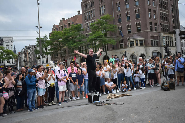 Street artist locked in chain in Amsterdam, Dam square