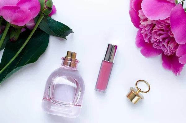 Pink peony flower bottle of perfume and lipstick pink woman mood Flat lay Nature concept on white background with copy space. Mother\'s Day and spring background concept.