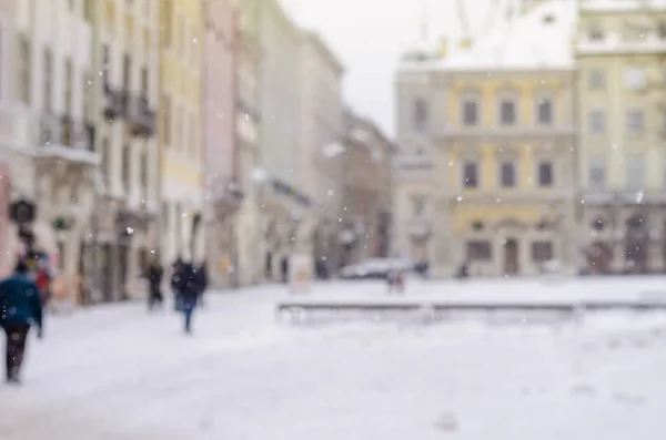 Blurred winter background city life bad weather lifestyle blizzard christmas cold falls snow tourists panorama old city