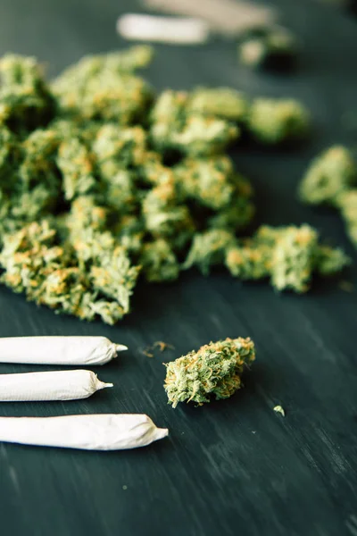 Macro de cannabis bourgeons marijuana avec trichomes et herbe écrasée sur une table noire insta gros plan — Photo