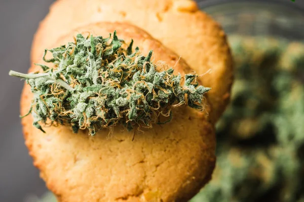 En burk cannabis knoppar begreppet matlagning med cannabisblad Cbd Cookies med cannabis knoppar och knoppar av marijuana på bordet. — Stockfoto