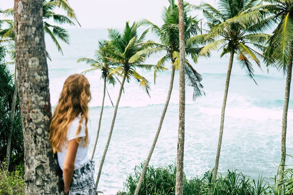 Woman under palm tree at beach Mirisa Sri Lanka close up