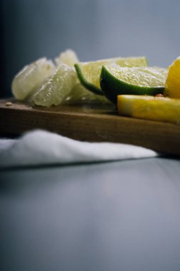 Bir yığın narenciye dilimi. Portakal, limon, greyfurt, pomelo. Tahta masada.