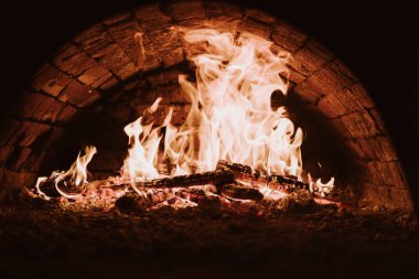 Kömürlerin pizza. Koyu arka plan. Bir yanan fırında pişirme kavramları. Yakın çekim. Fırında yangın.