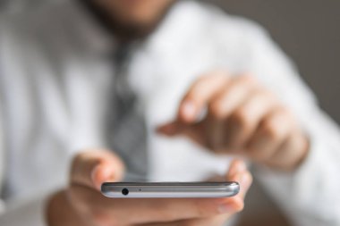 Online alışveriş. Office iş kavramı. Gönderen e-posta, hareket eden telefon. İşadamı bir akıllı telefon kullanır. Beyaz arka plan. Telefonu kapatmak.