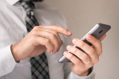 Açık renkli. Akıllı telefon elinde tutuyor. İş adamı iş bilgisayar ile ofis işleri tablo. Genç işadamı sakallı. Mali iş. Bir dizüstü bilgisayar ile ofis işleri.