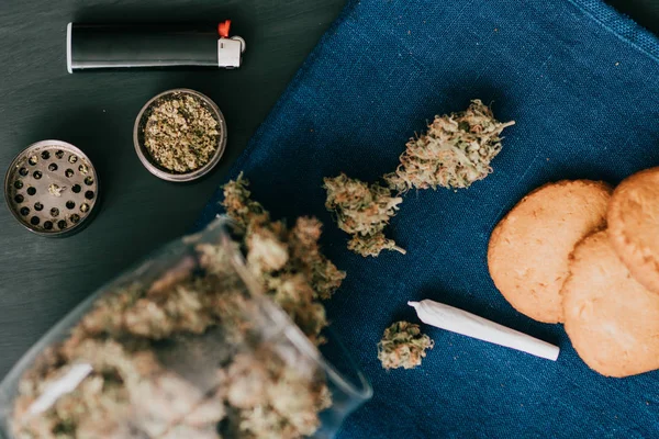 Cookies med marijuana. Godis med cannabis. Cannabis knoppar på en svart bakgrund. Bakning med tillägg av Cbd. godis med weed. — Stockfoto