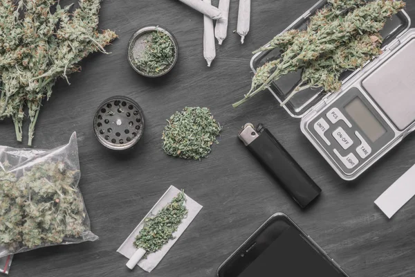 Cones of marijuana flowers on scales, grinder — Stock Photo, Image