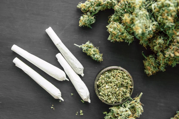 Joint van marihuana met schubben en geplette onkruid in een slijper voor hakken — Stockfoto