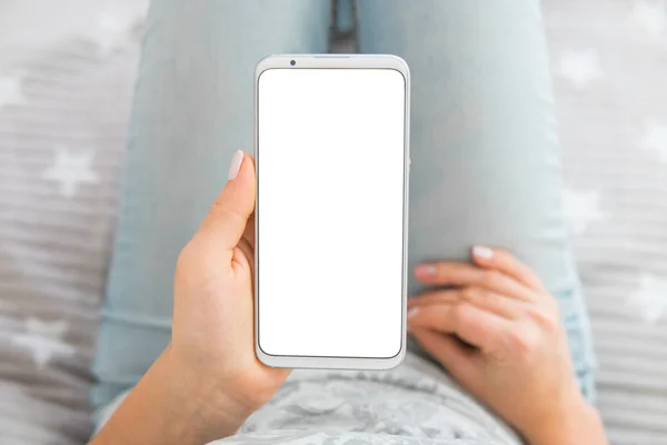 holding mobile phone white screen smartphone. top view. chroma key. Mockup image of woman's hands.