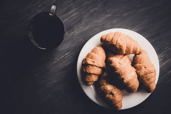 Makroschuss. Mate launische Farbe. Kaffee und frische Croissants auf schwarzem Hintergrund. Dessert und Kaffee. das Konzept des Frühstücks. — Stockfoto