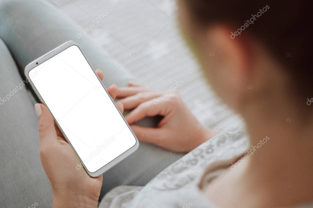 holding mobile phone white screen smartphone. chroma key. close up. Mockup image of woman's hands.