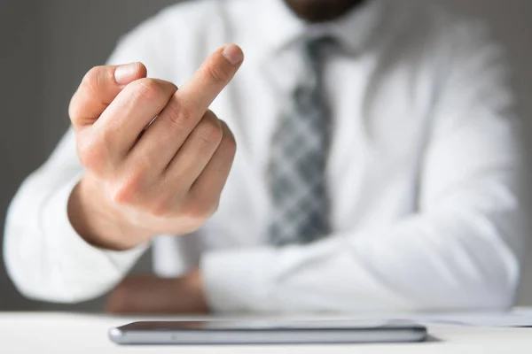 Businessman showing middle finger