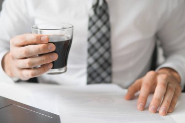 İş adamı iş bilgisayar ile ofis işleri tablo. Bir dizüstü bilgisayar ile ofis işleri. Genç işadamı sakallı. Akıllı telefon elinde tutuyor. Açık renkli. Mali iş.