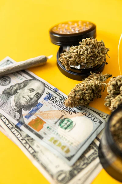 Marijuana bud and banknotes of dollars. Cannabis money black market. Money weed. Cannabis in Economics. Joint weed. Sativa THC CBD. Vertical shot .