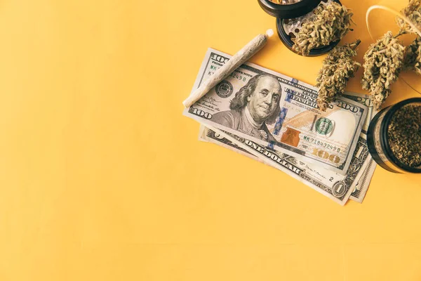 Marijuana weed bud and grinder. Marijuana bud and banknotes of dollars. Cannabis money black market. Money weed. Cannabis in Economics. Joint weed. Sativa THC CBD. Indica medical health.