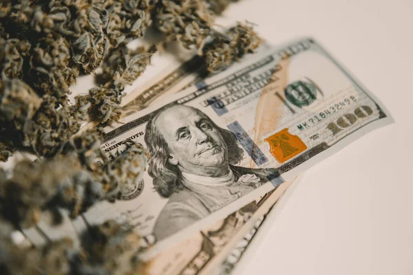 The pot buds. Cannabis money black market. White background. CBD THC herb. Cannabis in Economics .