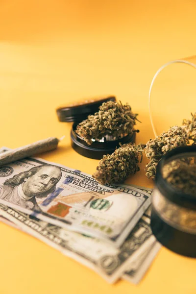 Joint weed. Marijuana weed bud and grinder. Indica medical health. Marijuana bud and banknotes of dollars.
