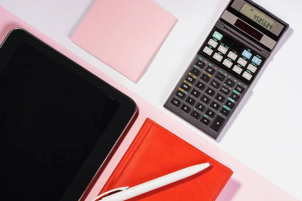 Office table with pen, calculator. Colour. Flat lay top view