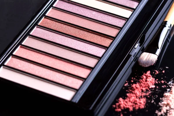 Palette of eyeshadow and brush on black background. Set of cosmetics. — Stock Photo, Image