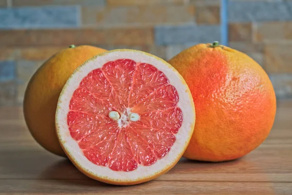 Red grapefruits on a wooden table