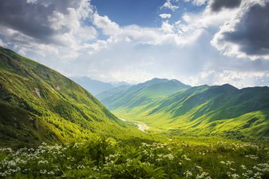 Dağlar aralıkları. Svaneti, Gürcistan'daki dağ manzarası. Güzel manzara çimenli tepeler ve yaylaları ile bulutlu gökyüzü güneşli gün yaz. Sahne dağlar doğa.