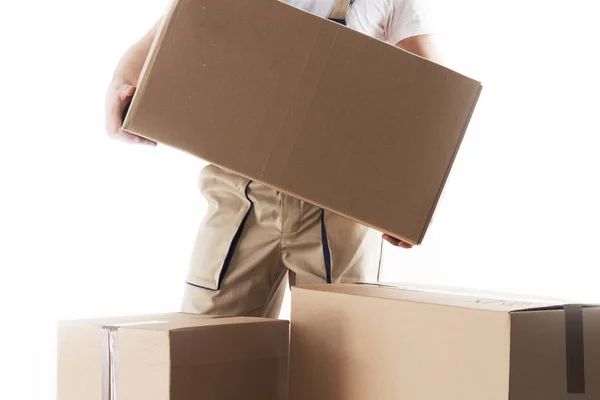 Man with cardboard box in hands. Relocation services. Mover with boxes. Loader. — Stock Photo, Image