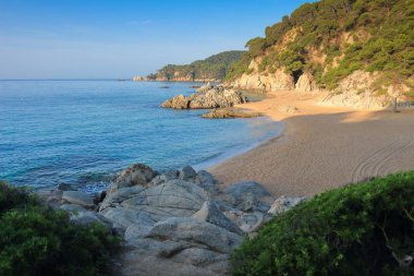 Akdeniz sahil Lloret de Mar. İspanyol harika Beach. Cala de Boadella platja. Denizde plaj manzara. Sandy beach kayalık sahil şeridi ile. Muhteşem plaj. İspanyol Deniz resort. Yaz tatili.