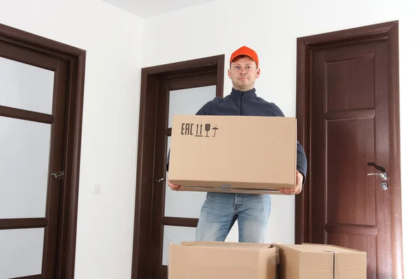 Free shipping. Courier with box in hands. Delivery man.