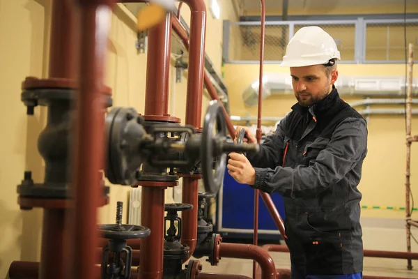 Mechanical engineer closes gate valve on pipeline