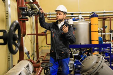 Teknisyen mühendis kapı kapak üzerinde petrol rafinerisi boru hattı açılır