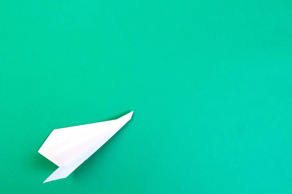 Travel and journey concept. White paper plane on green background. — Stock Photo, Image